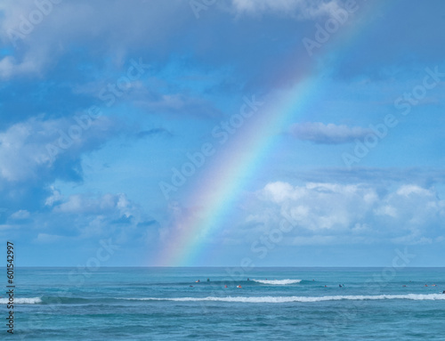 Rainbow and Rain Showers Above Surfers in Hawaii.