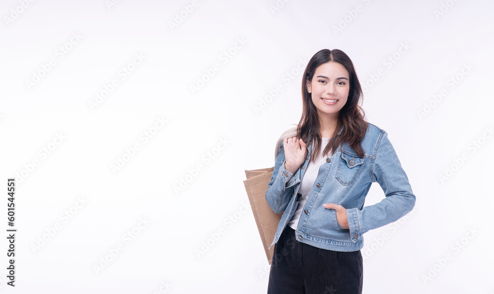 Cheerful shopper asian mixed race women holding tote eco handbag looking copy space on isolated white background. Beautiful happy young girl wear jacket jeans holding cotton cloth handbag for shopping Cheerful shopper asian mixed race women holding tote eco handbag looking copy space on isolated white background. Beautiful happy young girl wear jacket jeans holding cotton cloth handbag for shopping
