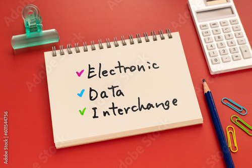 There is notebook with the word Electronic Data Interchange.It is as an eye-catching image. photo