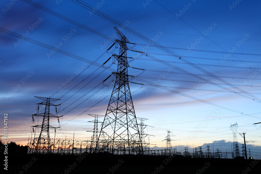 In the evening, the silhouette of high voltage towers