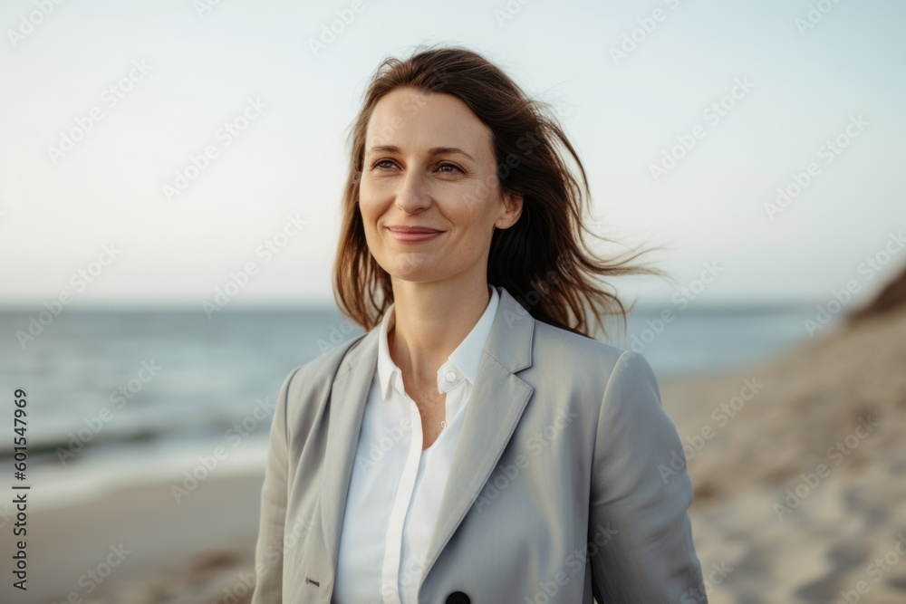 Portrait of a beautiful businesswoman in a suit on the beach Portrait of a beautiful businesswoman in a suit on the beach
