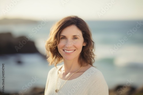 Portrait of smiling woman standing on the beach at the day time © Hanne Bauer