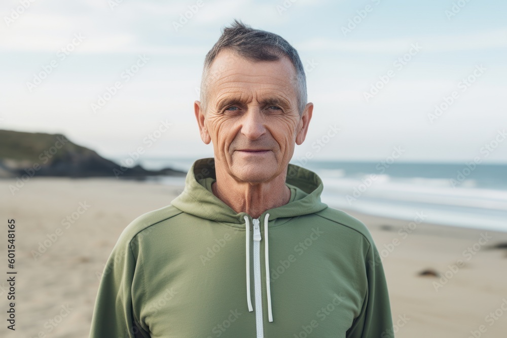 Portrait of senior man in sportswear looking at camera on beach