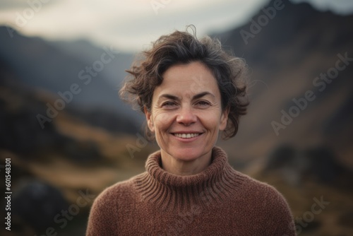 Portrait of smiling middle-aged woman in the mountains at sunset © Hanne Bauer