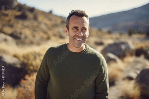 Portrait of smiling man standing in the desert and looking at camera