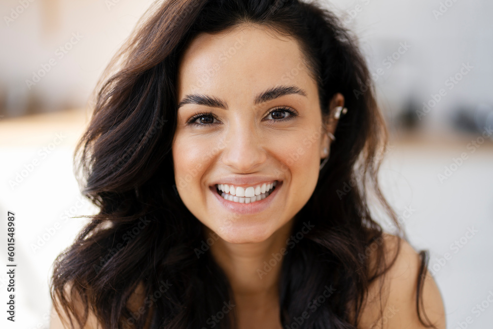 Closeup portrait of beautiful smiling latin woman looking at camera standing in kitchen. Positive emotions, healthy lifestyle concept 