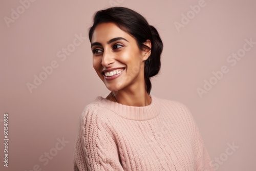 Portrait of a smiling young woman looking at camera isolated on a pink background