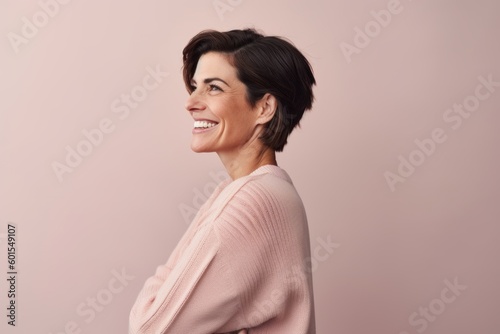 Medium shot portrait photography of a pleased woman in her 40s wearing a cozy sweater against a pastel or soft colors background. Generative AI