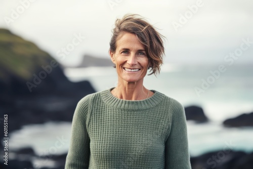 Portrait of smiling mature woman standing in front of camera at beach © Eber Braun