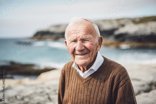 Portrait of a happy senior man at the beach, looking at camera