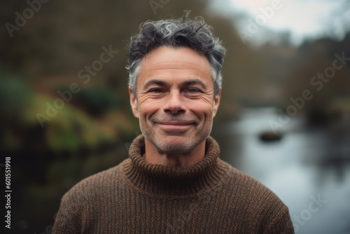 Portrait of a handsome middle-aged man smiling at the camera in a park © Eber Braun