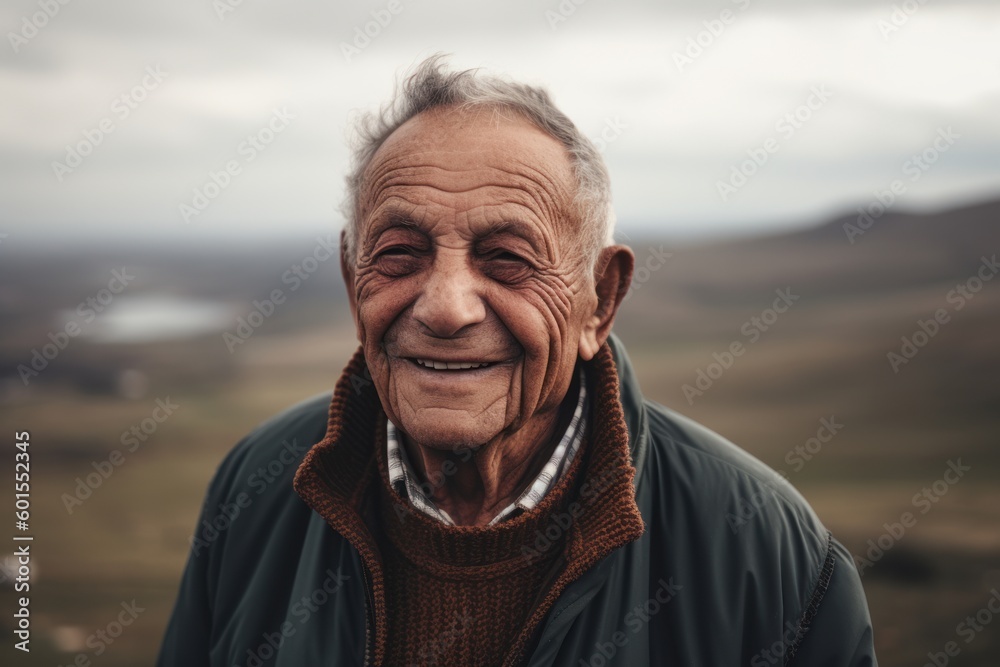 Portrait of an elderly man in the mountains on a cloudy day Portrait of an elderly man in the mountains on a cloudy day