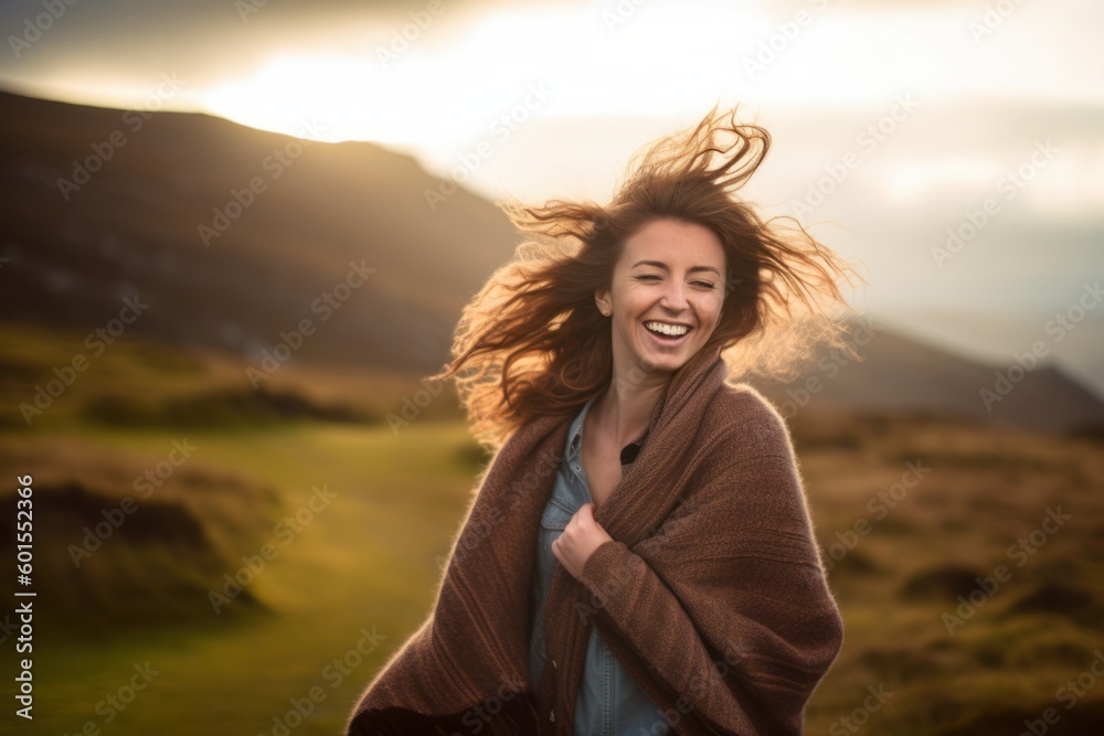 Portrait of a happy young woman with wind blowing her hair in the countryside Portrait of a happy young woman with wind blowing her hair in the countryside