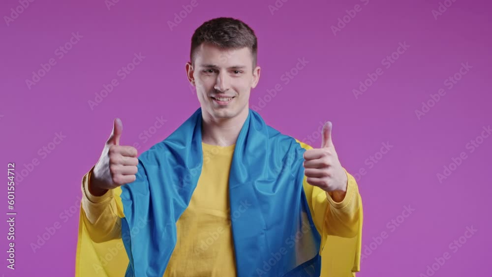 Smiling young man with national Ukrainian flag. Ukraine, patriot, victory in war Smiling young man with national Ukrainian flag. Ukraine, patriot, victory in war