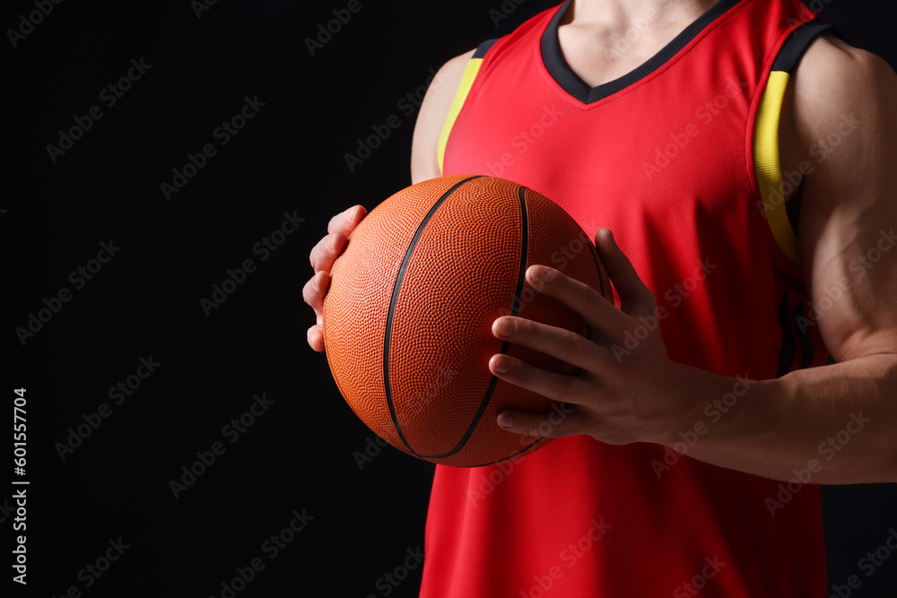Athletic man with basketball ball on black background, closeup. Space for text Athletic man with basketball ball on black background, closeup. Space for text