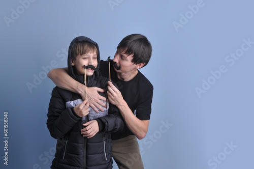 pai e filho brincando com bigodes, diverção no dia dos pais  photo