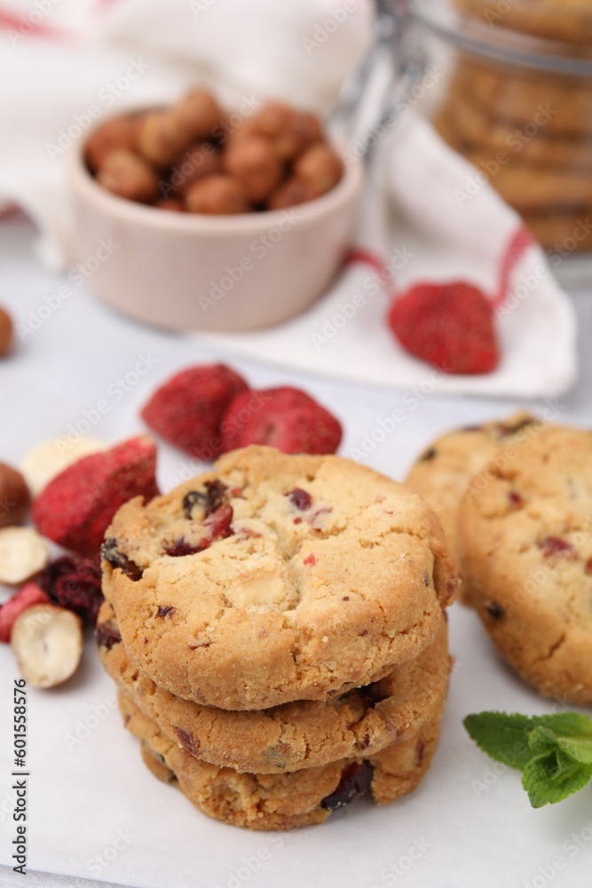 Cookies with freeze dried fruits, nuts and mint on white table, closeup Cookies with freeze dried fruits, nuts and mint on white table, closeup