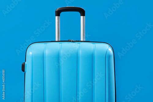 Blue suitcase on color background, closeup