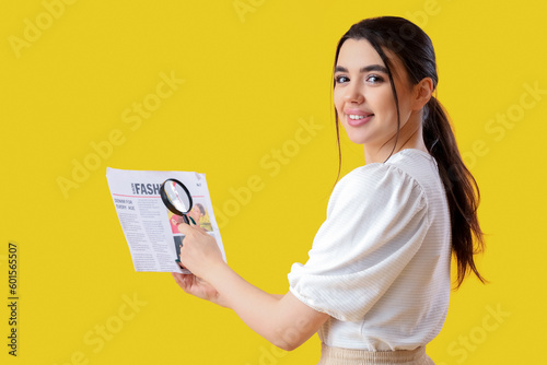 Young woman with magnifier ...