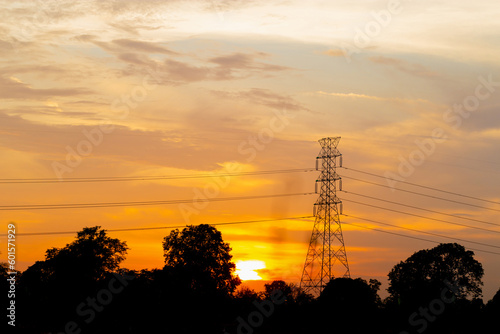 Silhouette of High voltage electric tower at sunset evening time, Sky at sunset time background