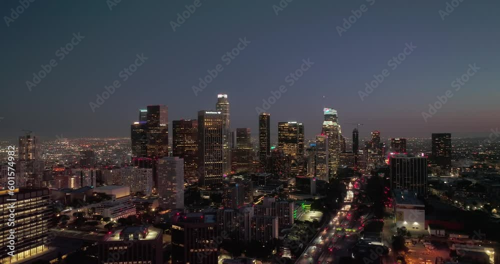 Los Angeles skyline aerial drone night downtown. Aerial shot of downtown Los Angeles skyscrapers at night. City lights and building towers from a drone with urban streets and traffic. Los Angeles skyline aerial drone night downtown. Aerial shot of downtown Los Angeles skyscrapers at night. City lights and building towers from a drone with urban streets and traffic.