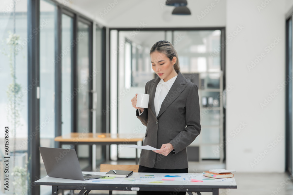 Young Asian businesswoman working on documents at office