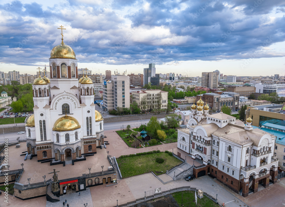 Summer Yekaterinburg and Temple on Blood in cloudy sunset. Aerial view of Yekaterinburg, Russia. Translation of the text on the temple: Honest to the Lord is the death of His saints.