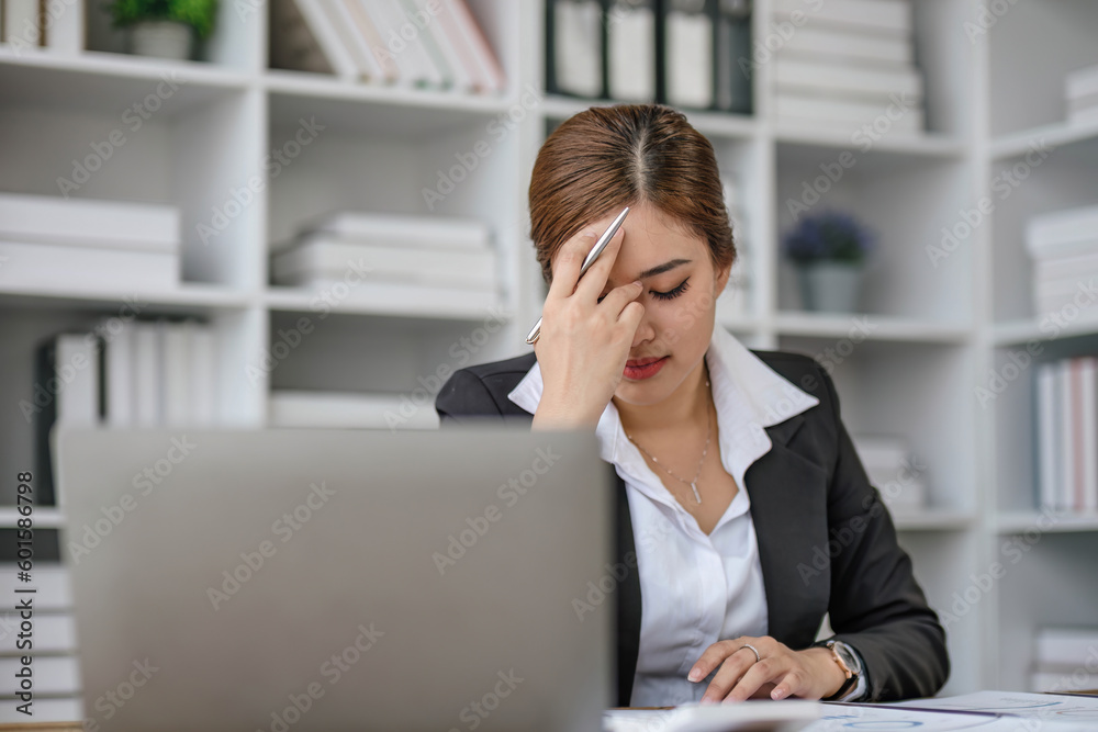 Tired Asian woman, stress woman-Asian young businesswoman with a headache at office, feeling sick at work, copy space Tired Asian woman, stress woman-Asian young businesswoman with a headache at office, feeling sick at work, copy space