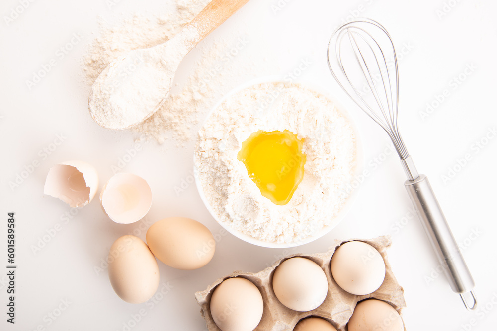 fresh chicken eggs with flour on a white background. cooking fresh chicken eggs with flour on a white background. cooking