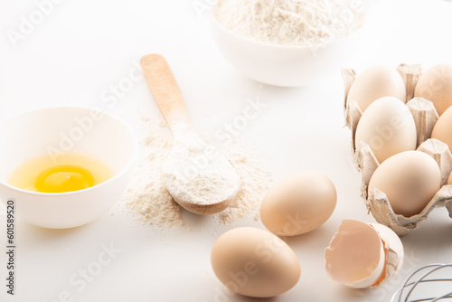 fresh chicken eggs with flour on a white background. cooking