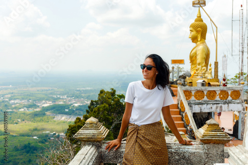 beautiful girl on the top of the mountain visits the Tiger Temple, Krabi, Thailand. Man enjoying the panorama of the mountains. photo