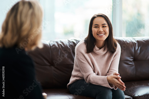 Therapy, happy women have a conversation on sofa and speaking or talking with a psychologist. Mental health or communication, support or consulting and people on couch have a discussion together