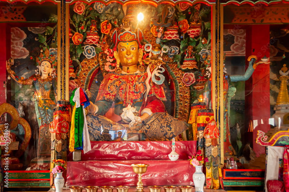 Sikkim, India - 22nd March 2004 : Glass covered colorful Buddist Gods and Godesses, often depicting earlier births of God Buddha, inside Buddhist Andhen or Andey monastery.