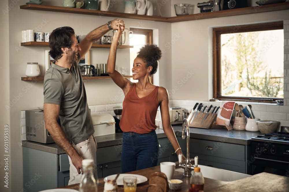 Happy couple, dance and fun bonding in kitchen for romance, love or holiday together at home. Interracial man and woman dancing in happiness for romantic relationship or enjoying weekend in the house - obrazy, fototapety, plakaty 