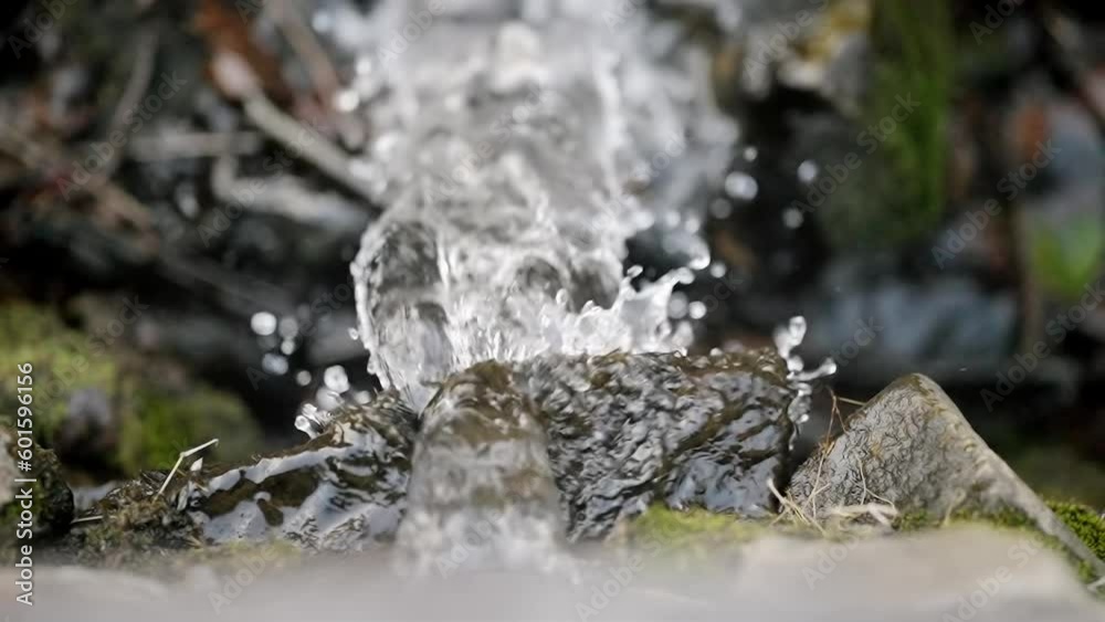 Top down view of water splashing and flowing on brick rock falls into stream, slow motion Top down view of water splashing and flowing on brick rock falls into stream, slow motion