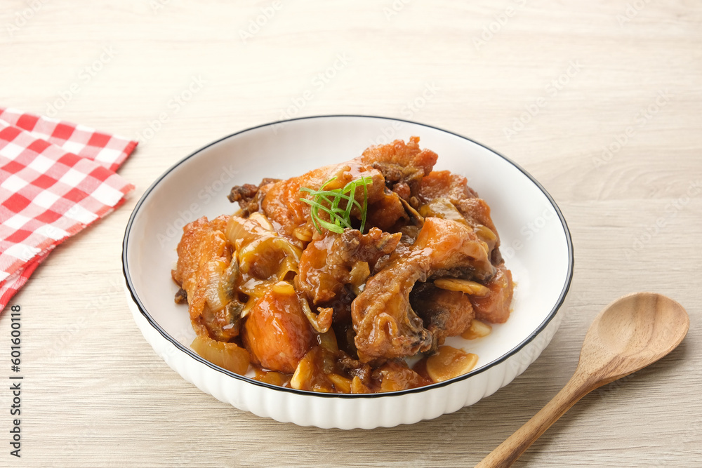 Ayam Goreng Mentega or Butter Chicken in white plate. Indonesian food.
Ayam Goreng Mentega or Butter Chicken in white plate. Indonesian food.
