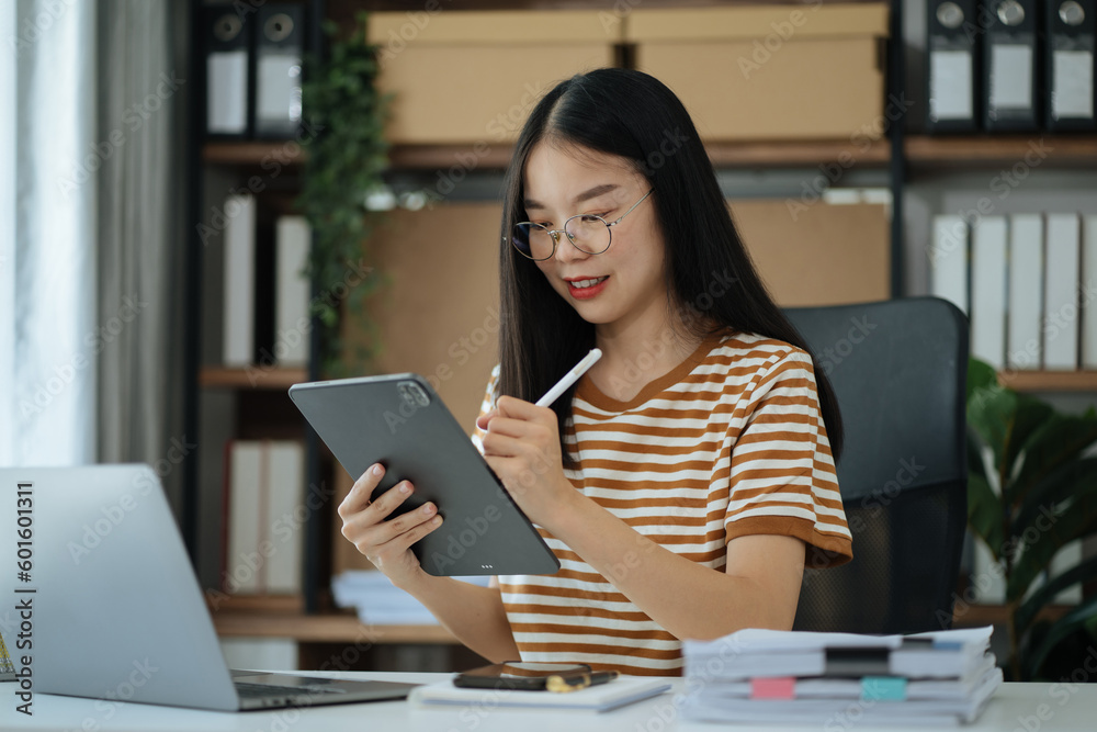 Fototapeta premium Send a message to a colleague, Female, confident in matching a tablet and sitting in home office.