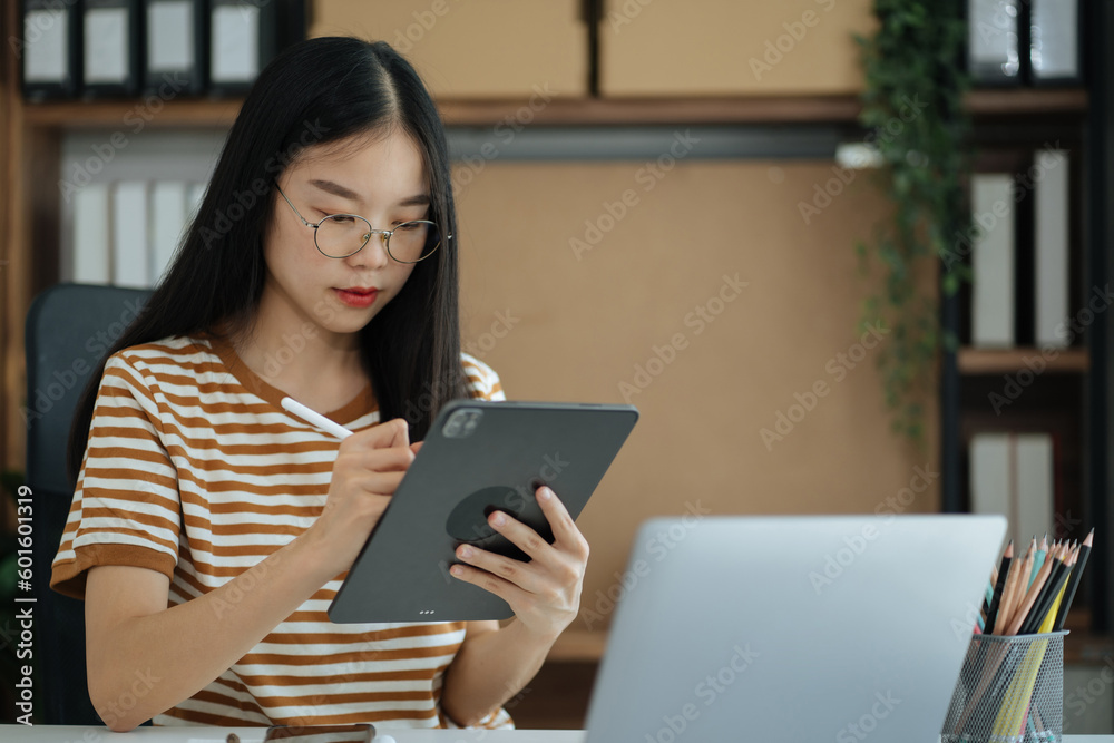 Send a message to a colleague, Female, confident in matching a tablet and sitting in home office. Send a message to a colleague, Female, confident in matching a tablet and sitting in home office.