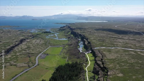 Tectonic plate in Thingvellir National Park with Oxararfoss Waterfall, Iceland. Aerial backward and panoramic view photo