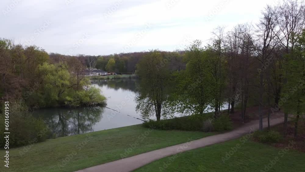 Lake in a park in Cologne Germany with a small house and forest around it Lake in a park in Cologne Germany with a small house and forest around it