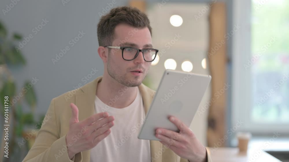 Portrait of Young Businessman Doing Video Chat on Tablet