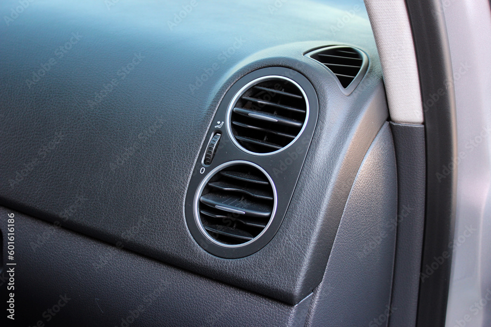 Interior of a modern car. Car conditioning. Car air vent grille. Vehicle vent interior for cold automobile cool. Auto climate condition. Hot air control panel. Car air conditioner.