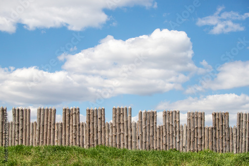 Wooden palisade against the sky  loopholes of the fortress.