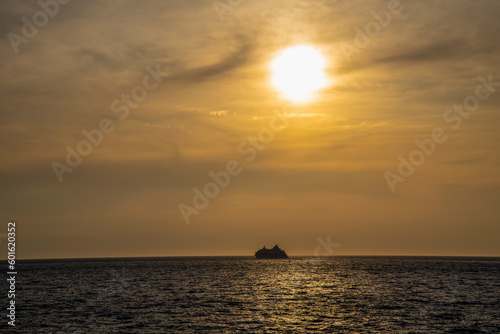 A cruise ship sails into the sunset on a summer day. © beast01