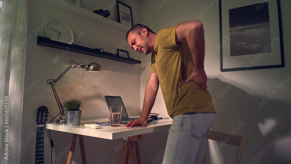 Man with hip, back, spine, hernia and sciatica pain at home.