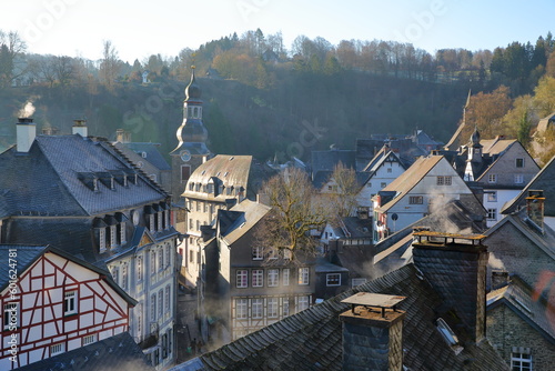 The historical center of the medieval town of Monschau, North Rhine Westfalia, Germany, on a misty winter morning, with half timbered house and the bell tower of the Evangelical City Church
