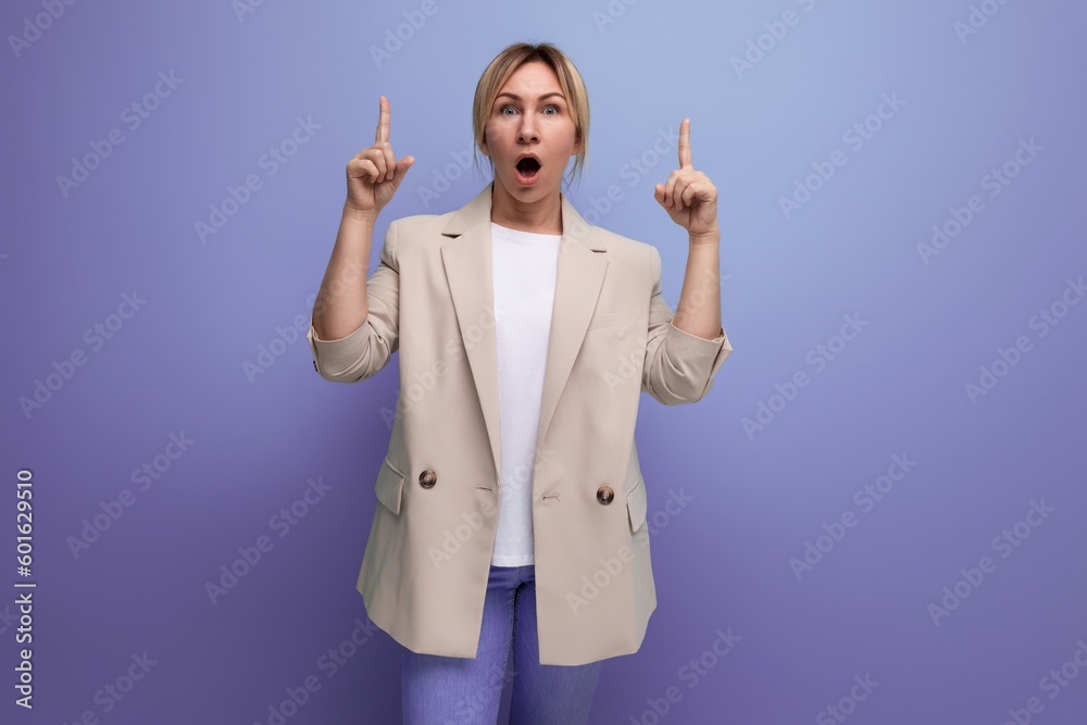 blond business woman in an office jacket shows the presence of insight on a studio background blond business woman in an office jacket shows the presence of insight on a studio background