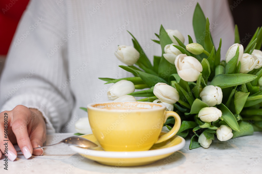 Photography of unrecognized woman with flowers and nude nails in white dress drinking cup of hot coffee inside Photography of unrecognized woman with flowers and nude nails in white dress drinking cup of hot coffee inside
