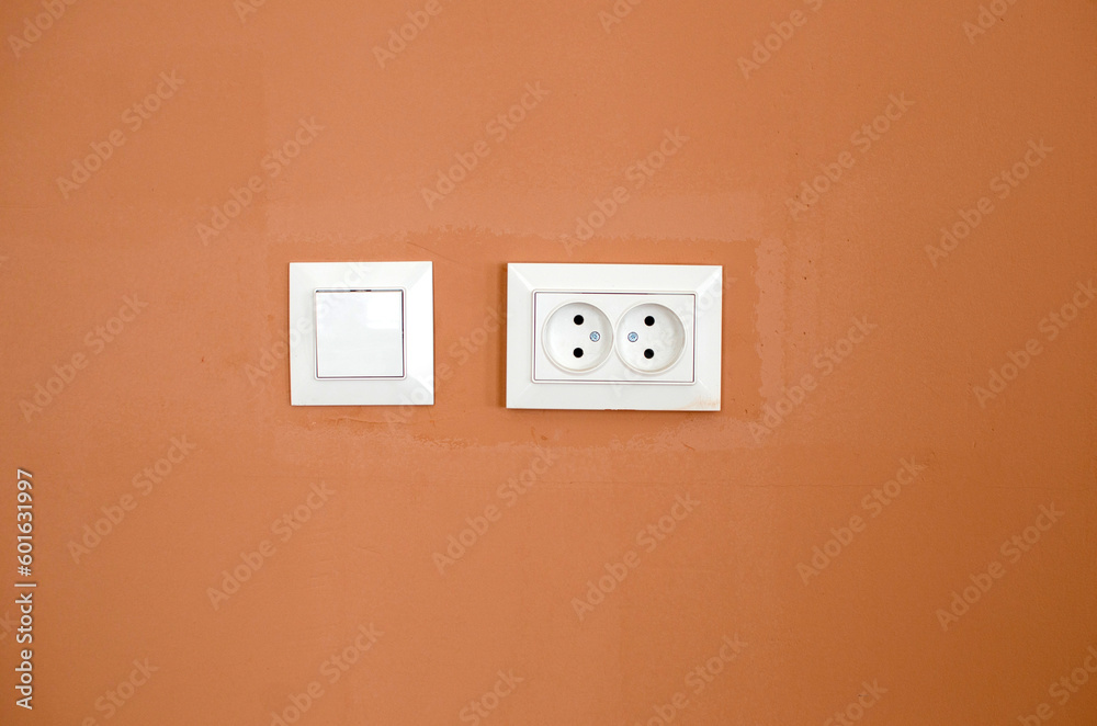 White switch light and socket on the wall White switch light and socket on the wall