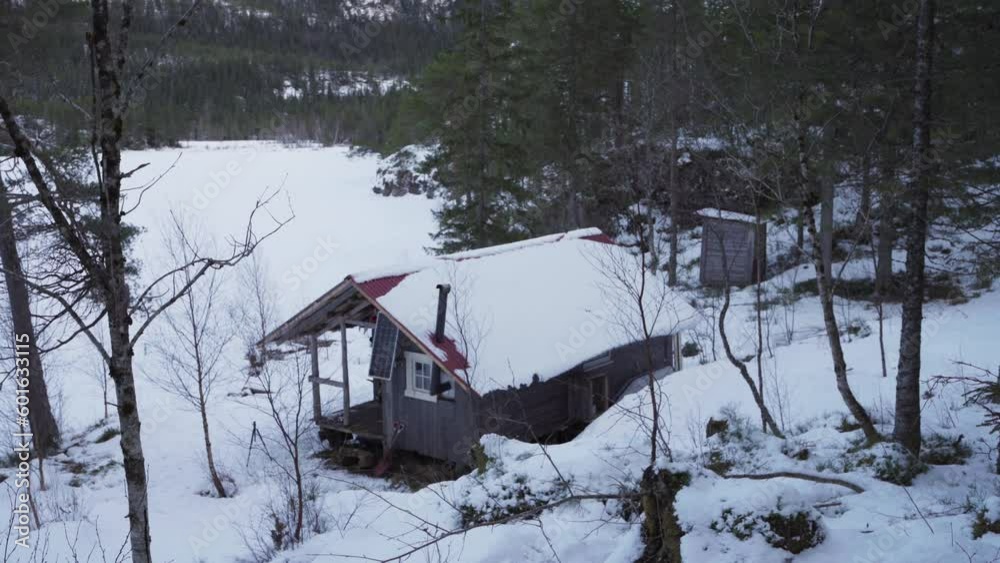 Log Cabin Covered In Snow At The Woods. High Angle Log Cabin Covered In Snow At The Woods. High Angle